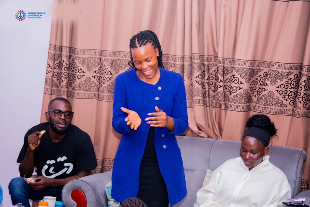 A facilitator leading a PPG Mental Health Clinic session with young people seated around her