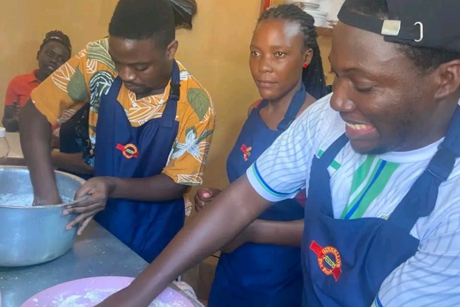 She Means Business participants kneading dough during a hands-on baking and food production session