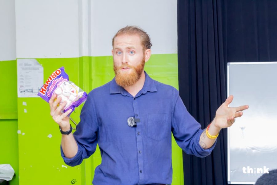 A facilitator introducing the marshmallow challenge during an Entrepreneurship 4 Peace session