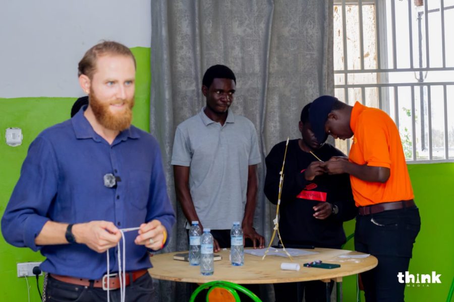 A facilitator preparing a team-building exercise as Entrepreneurship 4 Peace participants build