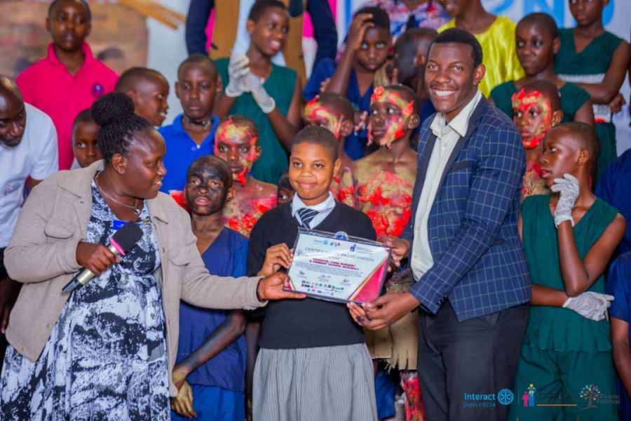 A pupil receiving a certificate of participation at the Annual Peace Festival