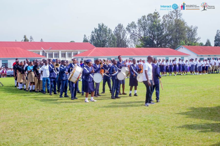 A school brass band performing on the field at the Annual Peace Festival
