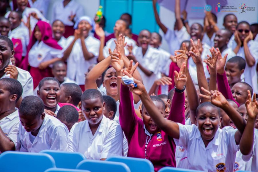 Students cheering with hands raised at the Annual Peace Festival
