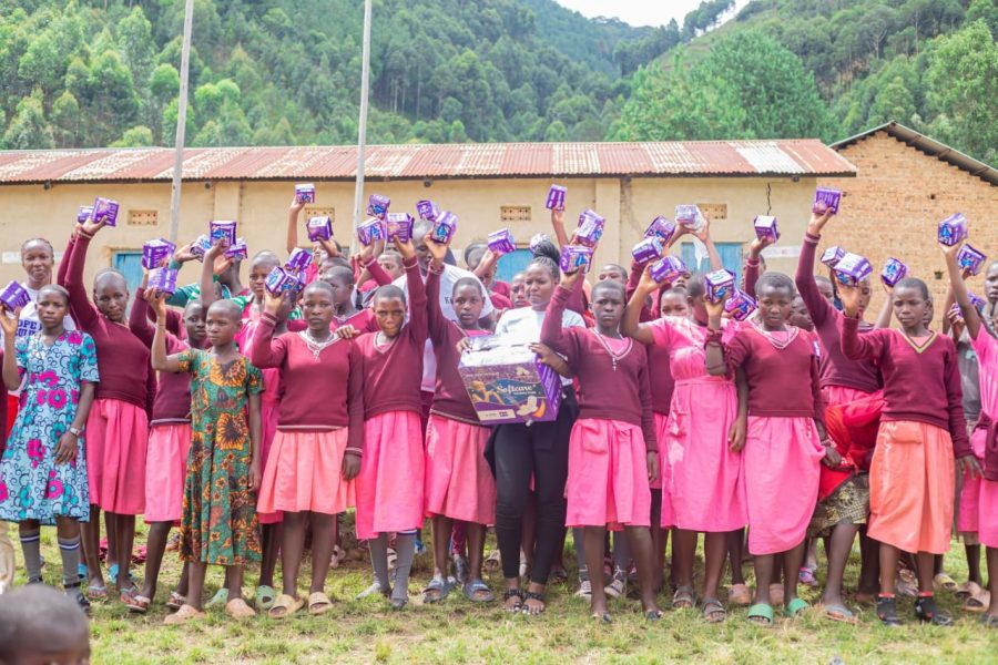Schoolgirls receiving sanitary pads through the Iziragobi Project menstrual health support